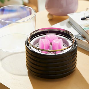 Three Fragrance Flame Wax Melts melting on an Electric Wax Melt Warmer